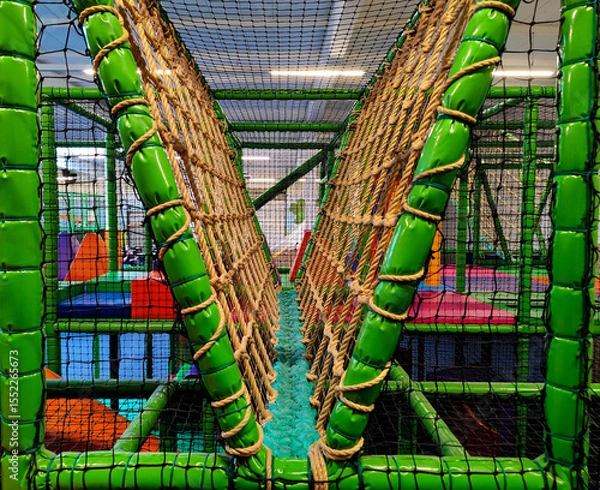 Fototapeta Indoor Playground Adventure Kids Soft Play Area with Rope Bridge and Colorful Obstacle Without Logos Or Trademarks