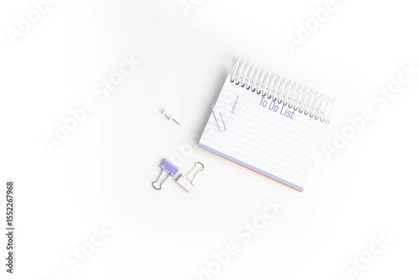 Obraz Purple To do list with 1, 2, and 3 listed on lined paper in a notebook with paper clips and push pins on white background,