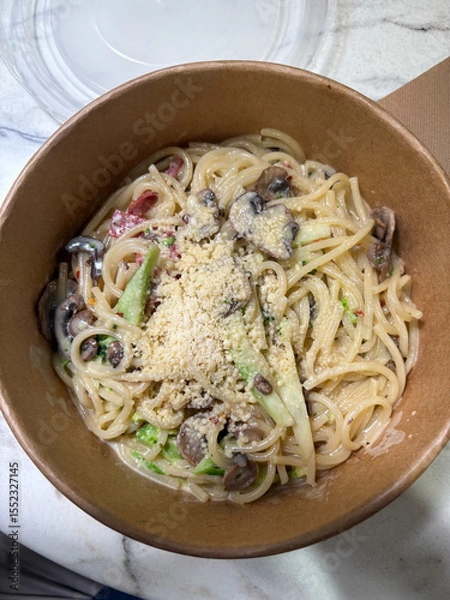 Fototapeta A bowl of mushroom spaghetti with cheese.