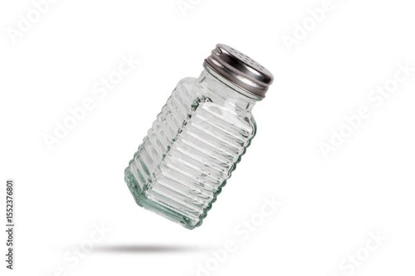 Obraz Salt shaker falling isolated on white background.