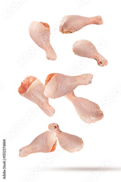 Obraz Falling raw chicken legs isolated on white background.