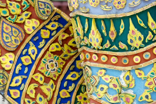 Fototapeta Colorful Traditional Artwork on Temple Columns in Thailand