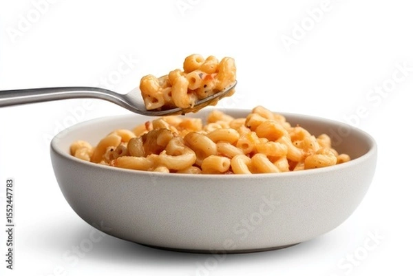 Obraz Side view of a spoon scooping rich and creamy macaroni and cheese from a large serving bowl