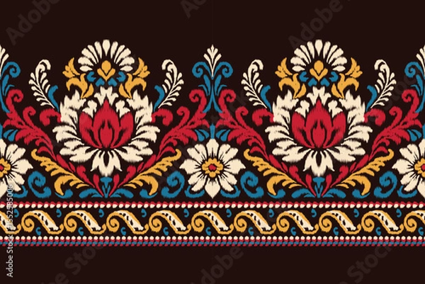 Obraz Colorful ikat floral pattern with traditional damask embroidery in red, yellow, and blue tones on black background, seamless ethnic textile design for clothing, decoration, fabric, and wallpaper.