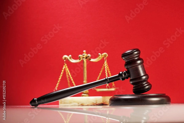 Obraz close up of the gavel hammer and libra scale against red background.