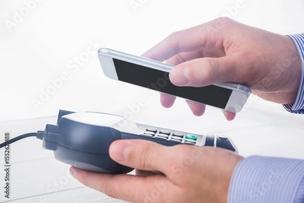 Obraz Man using smartphone to express pay