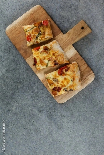 Obraz Pizza slices on wooden tray