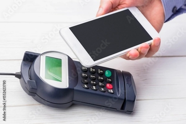 Obraz Man using smartphone to express pay