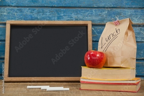 Obraz Blank blackboard with packed lunch and books