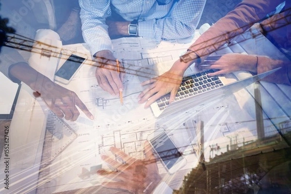Obraz Business people discussing over blueprint in office