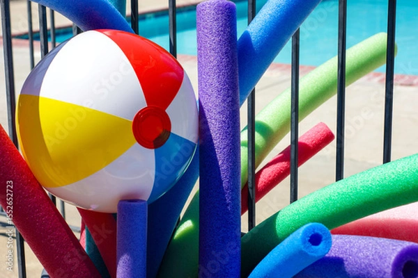 Fototapeta Close-up of colorful pool toys and beach ball