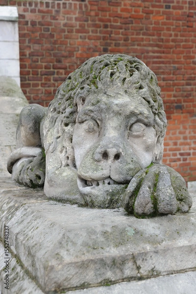 Fototapeta Old weathered sculpture of lion in front of City Hall at main square in Krakow, Poland
