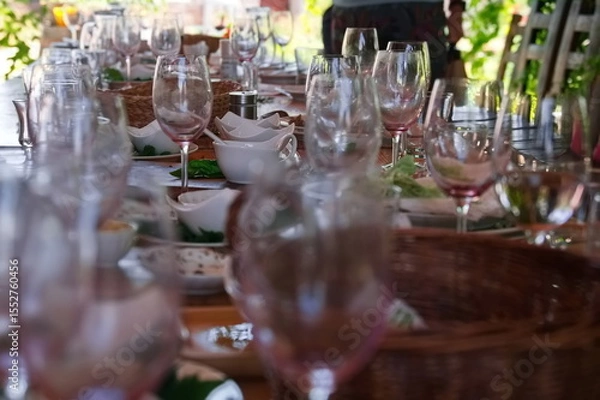 Obraz Wooden table after party with dirty dishes and wasted food