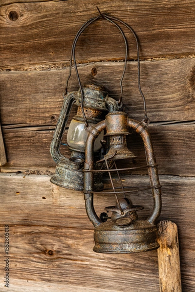 Fototapeta two old rusty lanterns on the wall