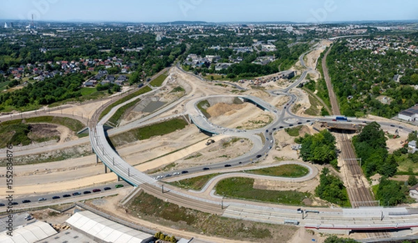 Fototapeta Krakow, Poland. Grebalow large highway and tramway interchange under construction. The fragment of S7 from Warsaw to A4 and last fragment of ring road around Krakow. Aerial view. State in January 2025