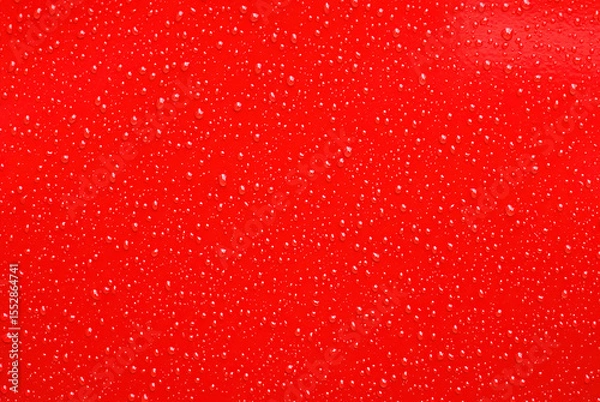 Fototapeta Red Surface with Shiny Water Droplets in Close-Up