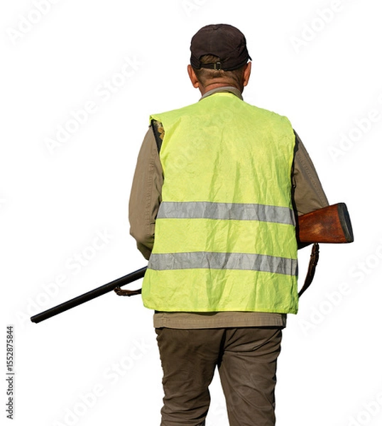 Fototapeta Mature man hunter with gun while walking on field.