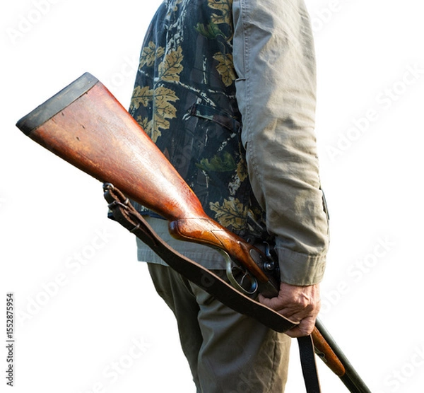 Fototapeta Mature man hunter with gun while walking on field.