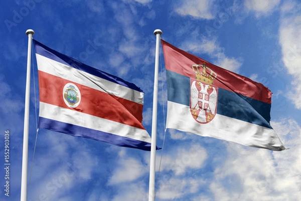 Fototapeta Costa Rica and Serbia National Flags Waving Proudly Under a Bright Blue Sky, Symbolizing Diplomatic Relations and International Friendship.