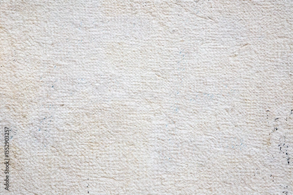 Fototapeta Textured Surface Of A Beige Stone Wall With Natural Cracks