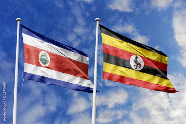 Fototapeta Flags of Costa Rica and Uganda Waving Together Under a Bright Blue Sky, Symbolizing Diplomatic Ties and African-Central American Relations.