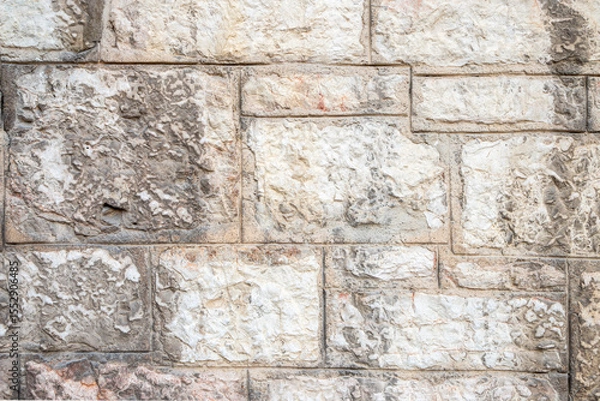 Fototapeta Close-Up of a Textured Stone Wall with Light and Neutral Tones