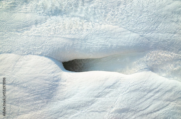 Obraz Hot mineral water stream running over textured white travertine surface in Pamukkale, Turkey.  Geothermal mineral waters gently flow, creating distinctive formations