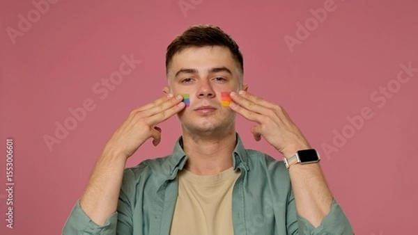 Fototapeta Man with Rainbow Stripes on Cheeks and Pink Background