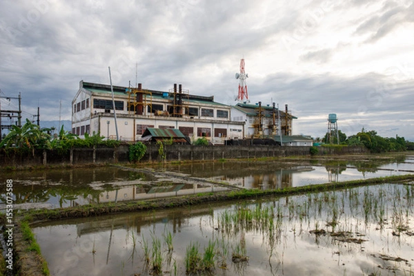 Obraz Abandoned Industrial Building Reflected in Flooded Rice Fields