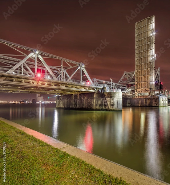 Obraz Massive illuminated bridge at night, reflected in the river, Port of Antwerp, Belgium