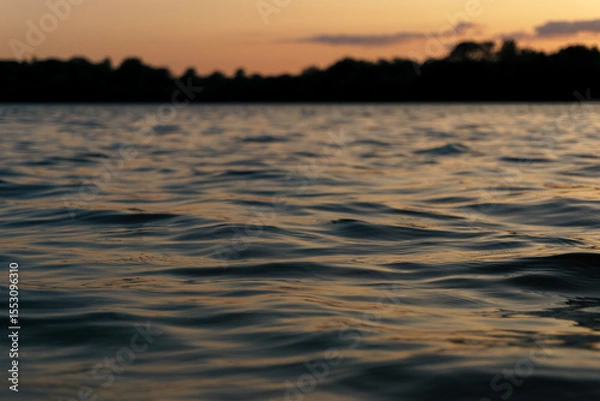 Obraz Ggentle waves rippling across a calm river surface.  Water texture is ideal for use as a natural background, meditative or peaceful ambient element. 