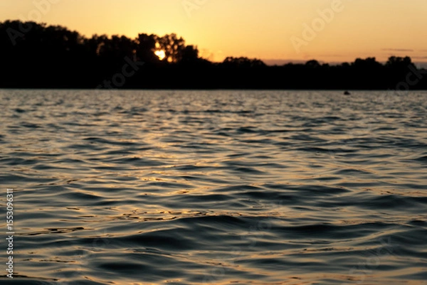 Obraz Ggentle waves rippling across a calm river surface.  Water texture is ideal for use as a natural background, meditative or peaceful ambient element. 
