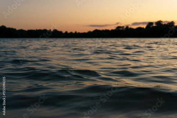 Obraz Ggentle waves rippling across a calm river surface.  Water texture is ideal for use as a natural background, meditative or peaceful ambient element. 