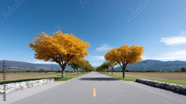 Fototapeta Paved Road Through Autumnal Landscape with Yellow Trees and Mountains