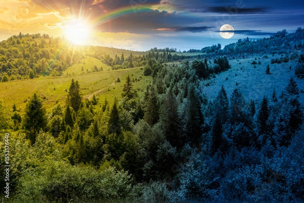 Obraz summer landscape with forest on the hill. scenic view of highlands with sun and moon at twilight. mysterious environment with trees in green foliage. scenery under dark blue sky and rainbow
