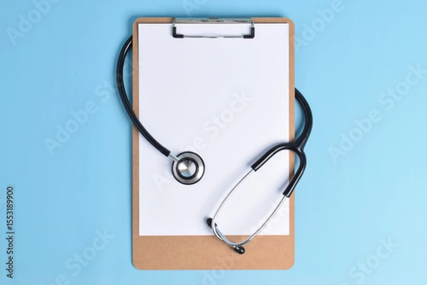 Obraz Blank clipboard with stethoscope on light blue background. World Health Day