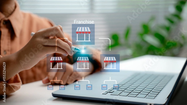 Obraz Franchise business model development shown by entrepreneur managing multi-level store network on laptop, concept of scalable investment, expansion strategy, and digital retail system.