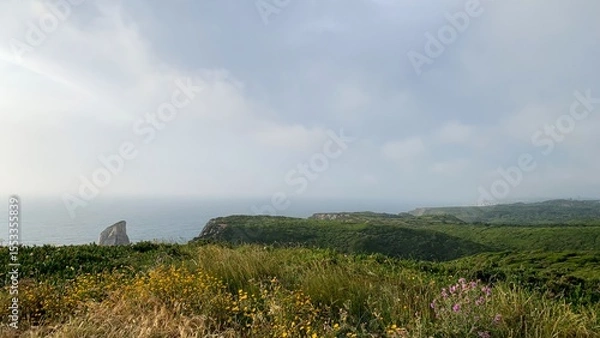 Fototapeta Expansive coastal vista under brooding skies invites contemplation and solitude, ideal for Earth Day reflection and Vernal Equinox rituals