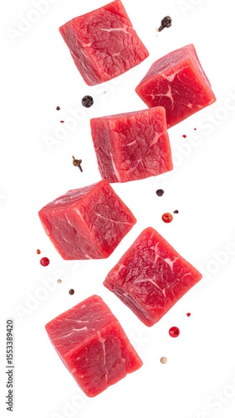 Fototapeta Raw Beef Cubes And Seasoning Spices Falling Against A Transparent Background Showcasing Red Meat Texture And Culinary Ingredients