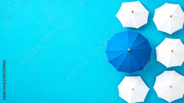Obraz Top view of five white umbrellas and one blue umbrella on a bright blue background.