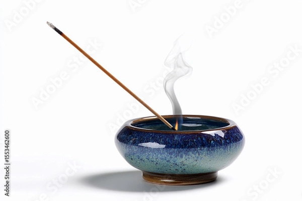 Obraz Incense stick burning in decorative bowl with smoke rising