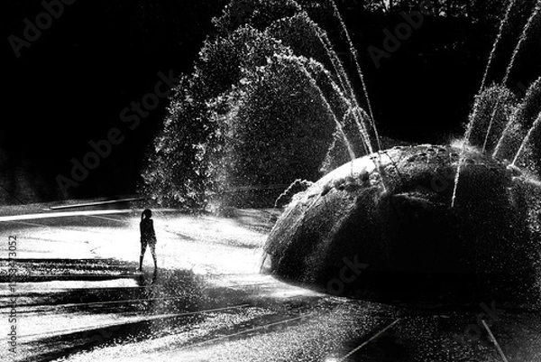 Obraz Silhouette of Kids Children Playing in Fountain in a City Park During the Summer