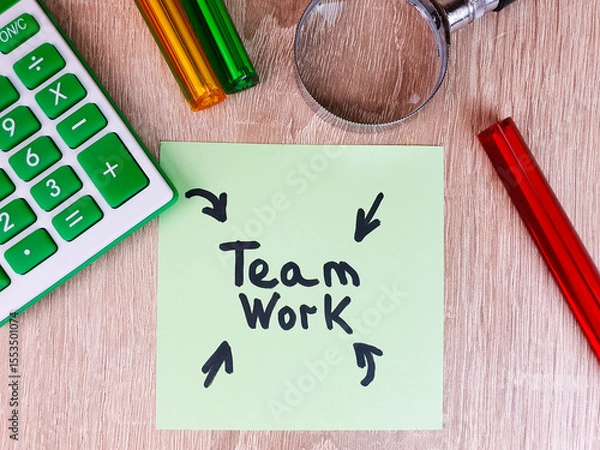 Obraz Teamwork,business,text,word,writing,note on a sheet on the table, teamwork with calculator, magnifying glass and pens,concept.