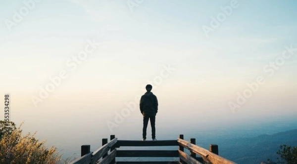 Obraz Man looks at a landscape from the top of the observation point