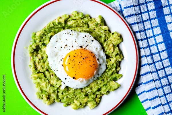 Obraz Healthy Fried Egg On Mashed Avocado Meal