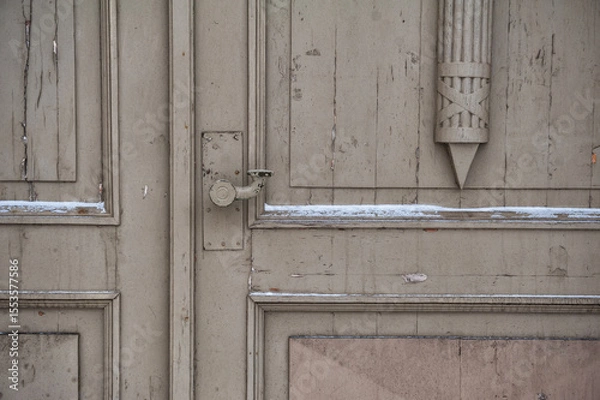 Obraz An antique wooden door with chipped handle and symmetrical panel detail