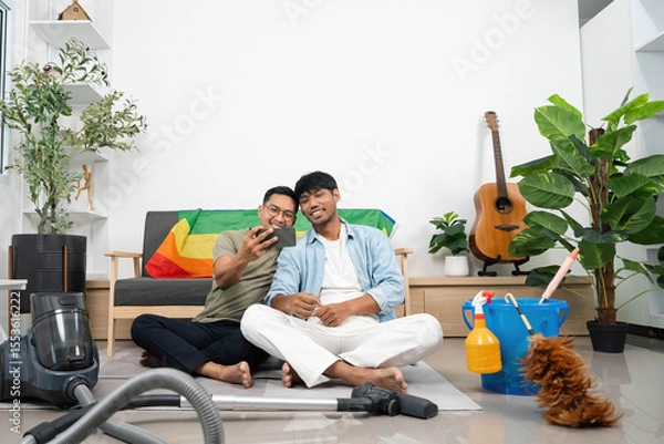 Obraz LGBTQIA Friendship and Connection. Two young men taking a selfie while enjoying their time at home.