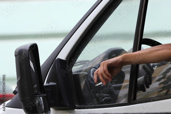 Obraz Hand with cigarette in open car window