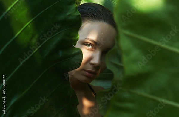 Obraz beautiful summer girl in palm leaves. young wet woman under palm tree in jungle