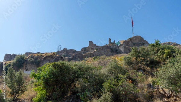 Fototapeta Ruins and fragments of walls of medieval Crusader castle, built in XV century by Knights Hospitaller of Order of St. John on hill above city of Fethiye, Turkey